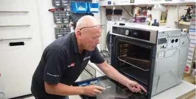 Technician servicing a built-in wall oven